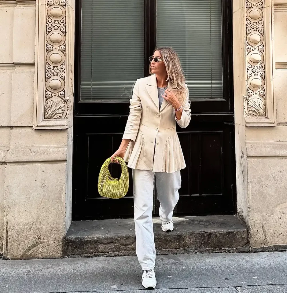 d classic white New Balance sneakers, the result is a polished outfit with comfort at its core. The beaded lime-green bag adds a playful, modern twist.