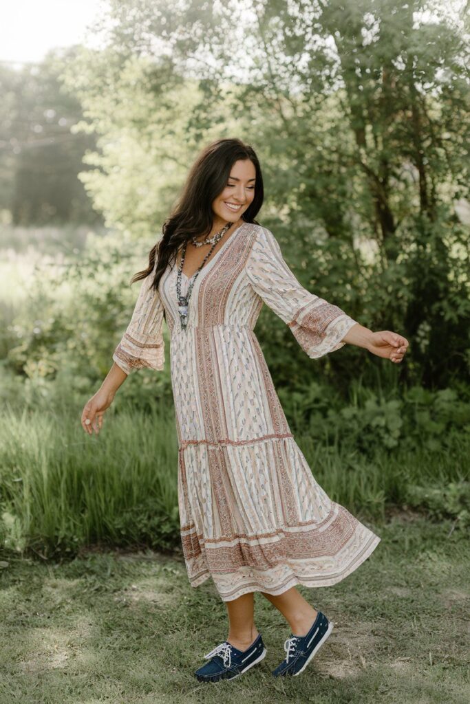 Visualize a carefree outfit with a bohemian print dress paired with classic boat shoes, ideal for a sunny day out.