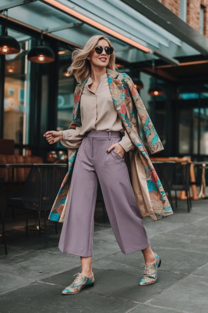 woman in culottes and a soft blouse, paired with vibrant, patterned oxford shoes that add a vintage yet modern flair.