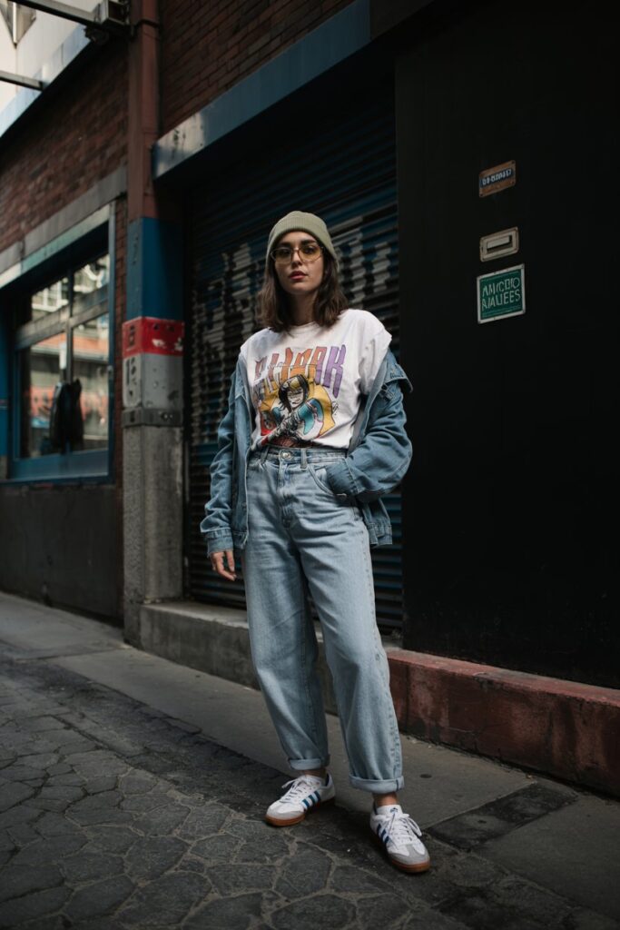 Tuck a retro band tee into high‑waist, light‑wash baggy jeans. Add a cropped denim jacket and well‑worn Sambas for that authentic Y2K revival