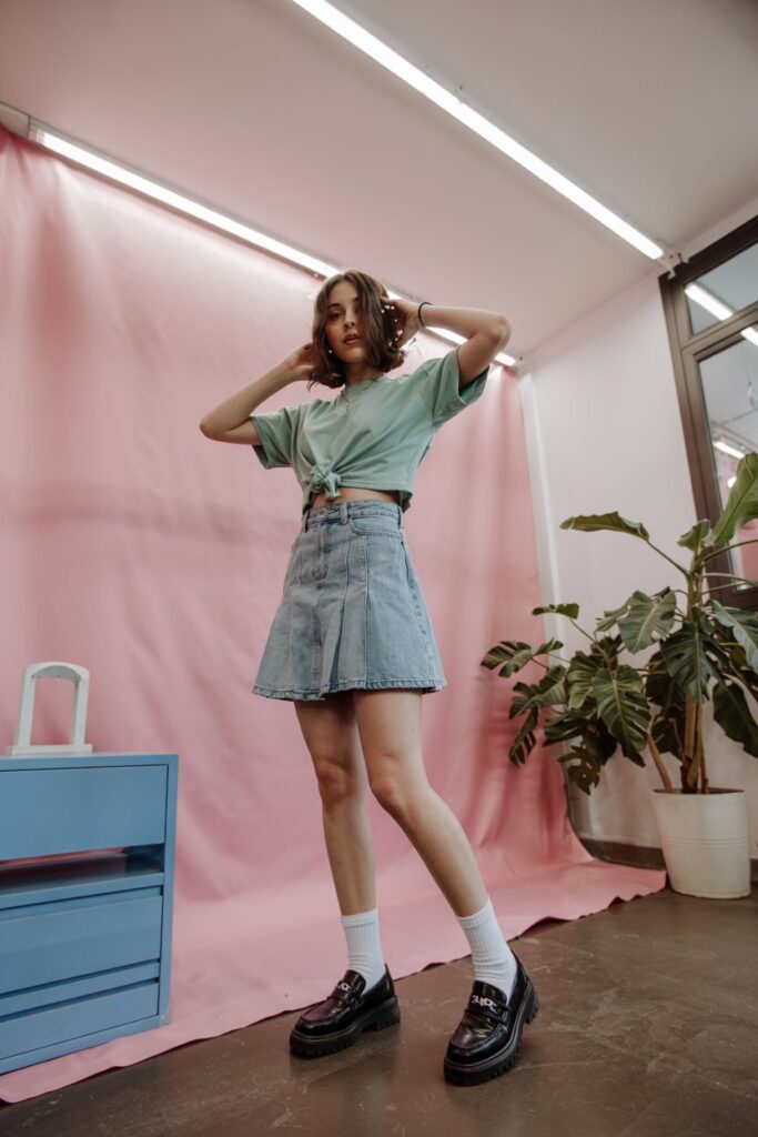 Y2K-inspired look with denim mini, chunky loafers, and baby tee.