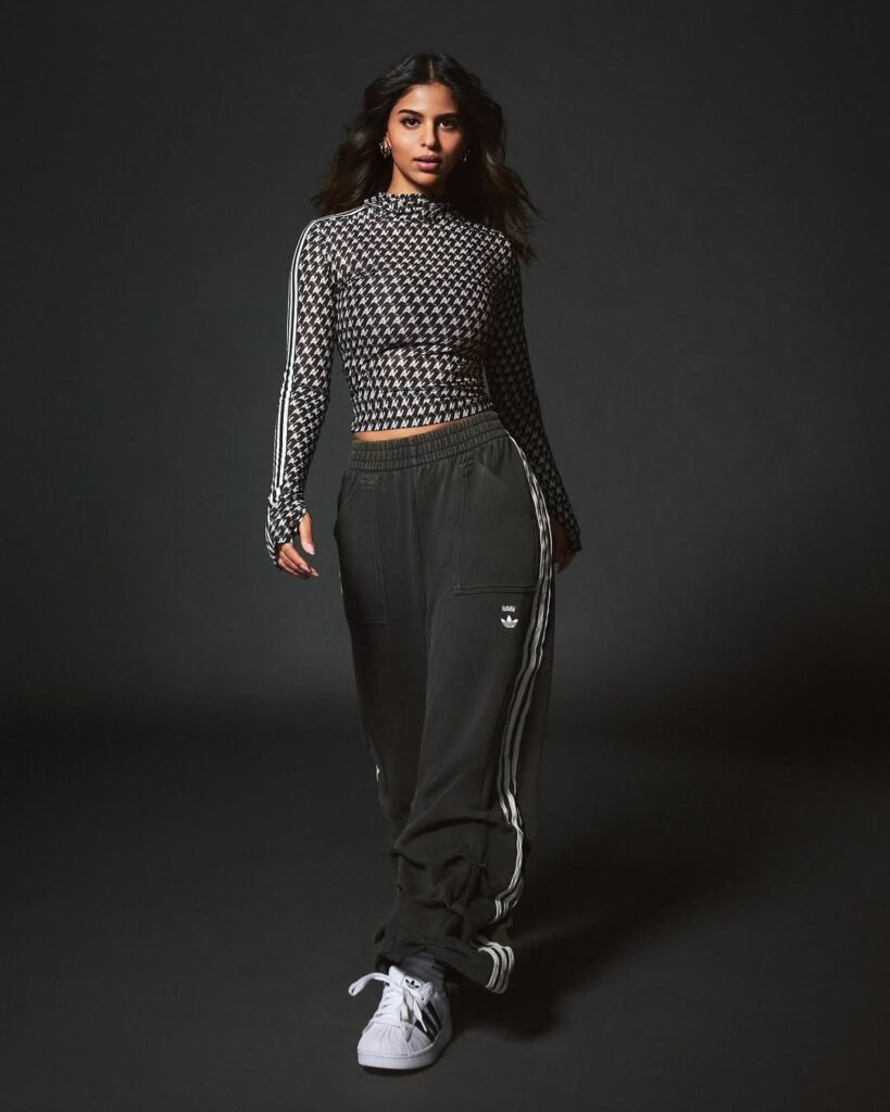 Monochrome has never looked this fierce. Pairing a black-and-white houndstooth mesh top with relaxed-fit Adidas track pants,