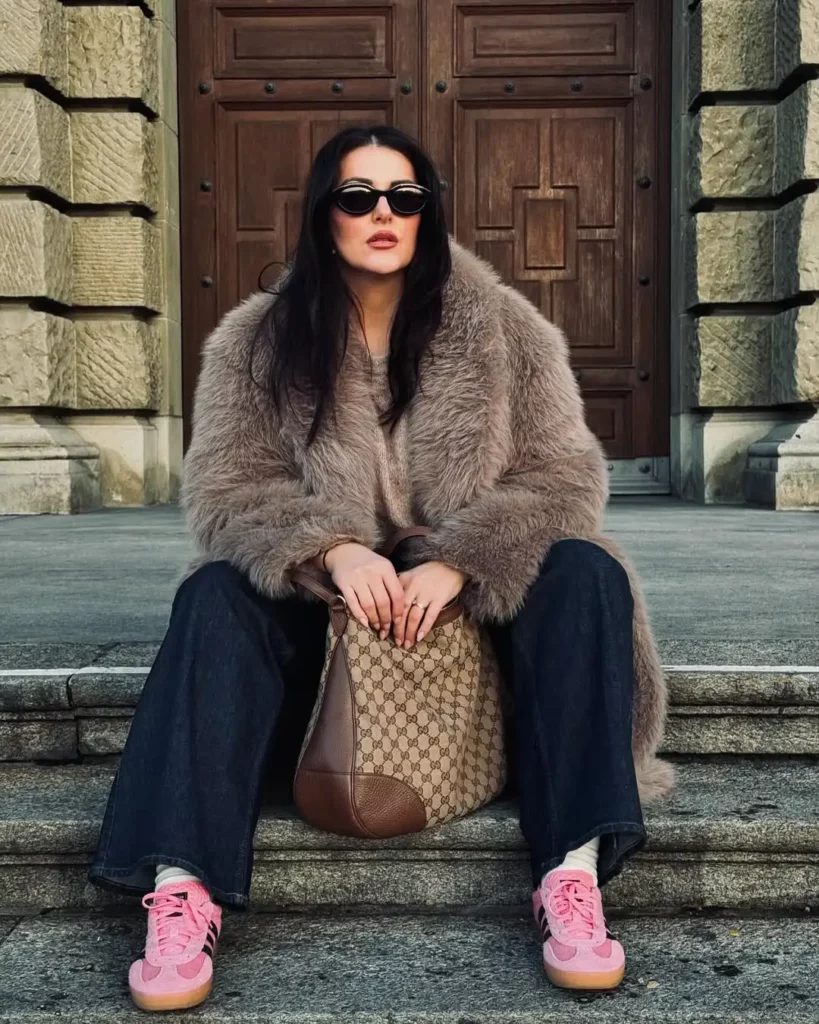 This look mixes drama and nostalgia with a voluminous faux fur coat layered over classic flared jeans. 