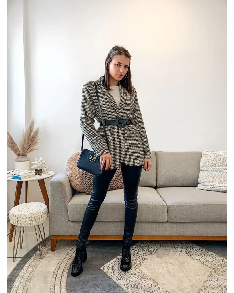 A tailored houndstooth blazer cinched with a statement belt creates a powerful silhouette, while faux leather pants add a touch of fashion-forward flair