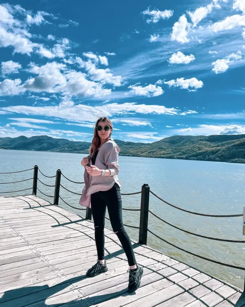 Pale pink button-down + black tank + ripped skinny jeans + black Adidas Ozweego