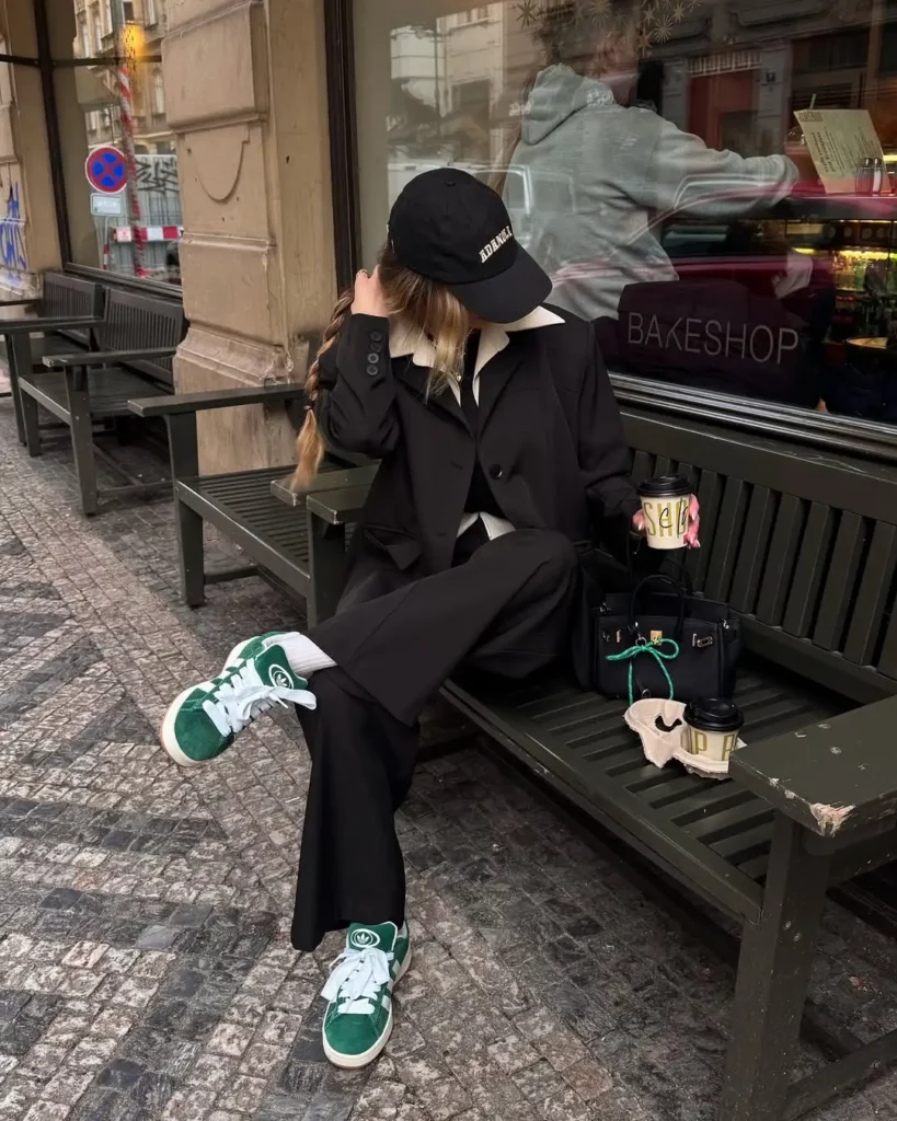 This outfit blends sharp tailoring with sporty flair—pairing green Adidas Campus 00s