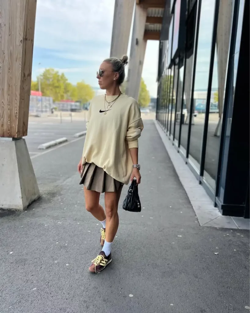 Oversized beige sweatshirt + pleated mini skirt + Adidas SL 72 in burgundy/yellow