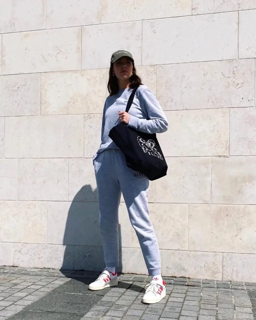 Grey sweatsuit + olive cap + red-accent Adidas Forum Low