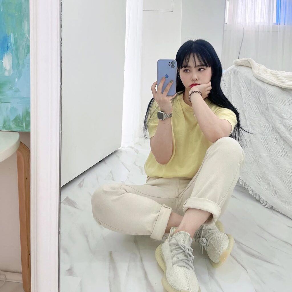 relaxed pastel yellow tee paired with cuffed cream joggers makes the Yeezy Boost 350 V2