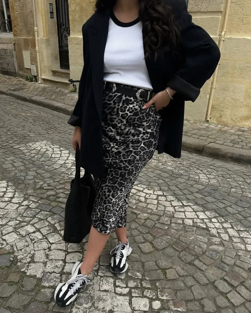 A leopard midi skirt brings bold energy to the classic black-and-white palette, while the oversized blazer tones things down just enough. Grounded by chunky New Balance sneakers,