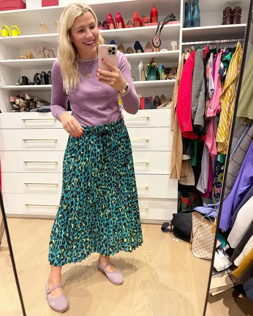 This outfit is all about color confidence. The soft lilac sweater pairs unexpectedly well with the bold teal leopard-print pleated skirt,