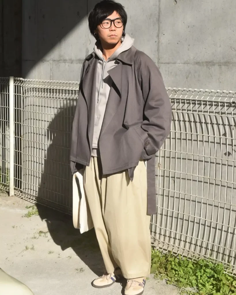 The pale-toned Adidas Sambas add contrast while keeping the color palette cohesive and muted.