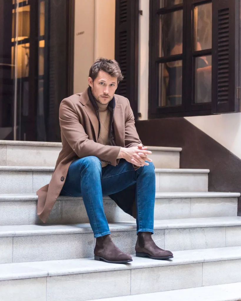 Camel Overcoat + Sweater + Blue Jeans + Brown Chelsea Boots