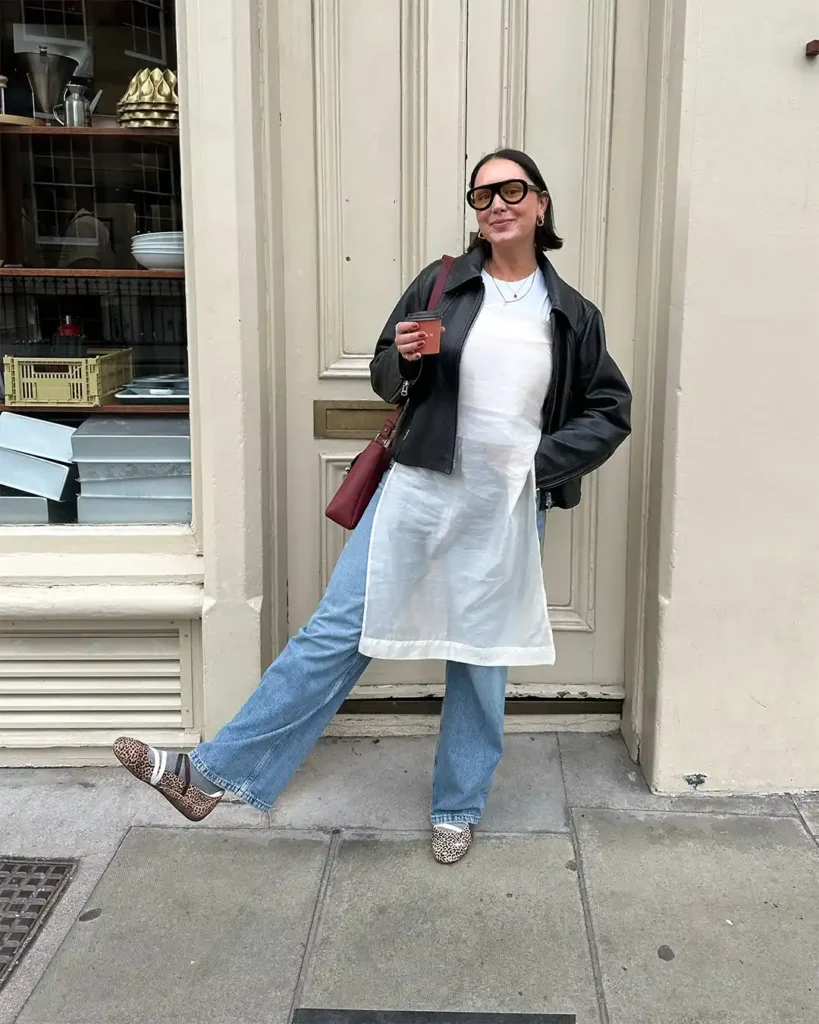 Leather Jacket Layered Over a White Dress and Wide-Leg Jeans