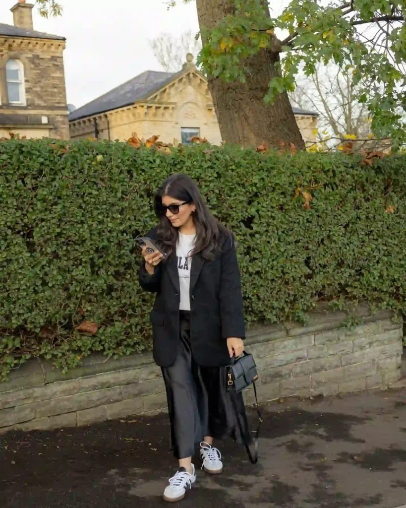 Black Coat with Satin Skirt and Sneakers Outfit