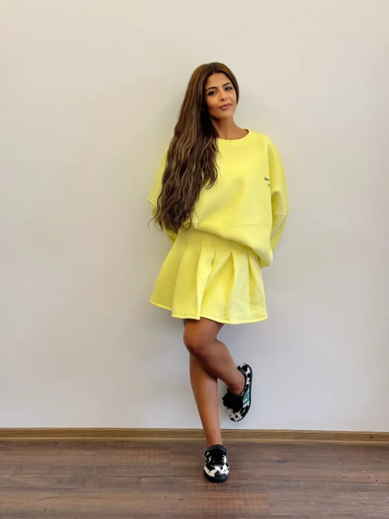 Bright Yellow Pleated Skirt with Oversized Sweatshirt and Sneakers