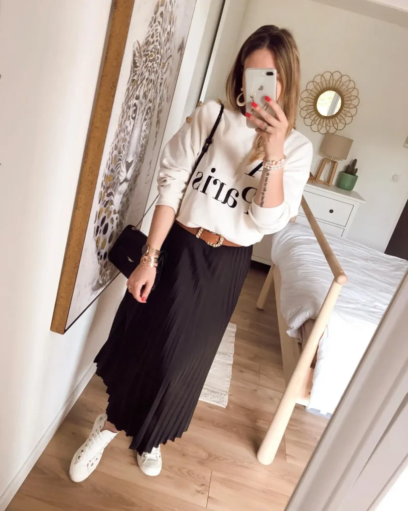 Black Pleated Midi Skirt with Graphic Sweatshirt and Sneakers Outfit