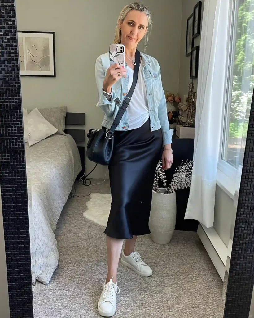 Light Denim Jacket with Black Satin Skirt and Sneakers