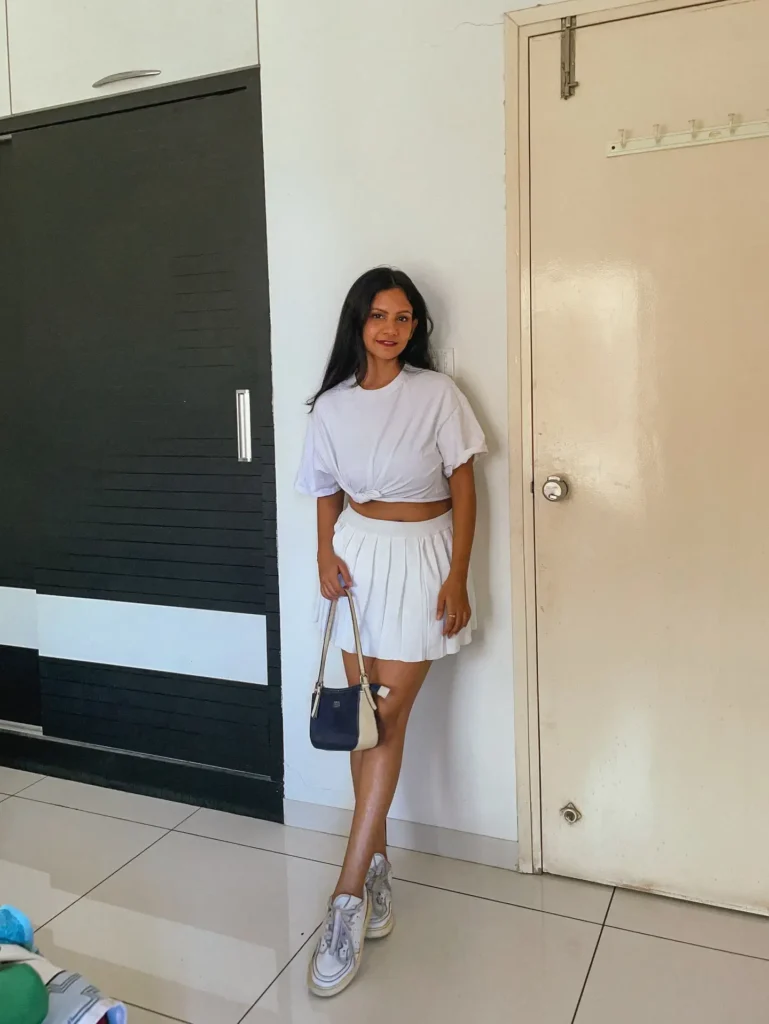 White Knot Tee with Pleated Skirt and Sneakers Outfit