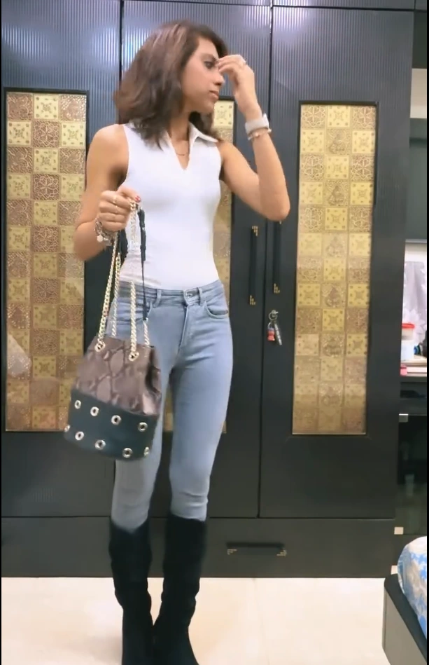 White Sleeveless Top with Skinny Jeans and Knee-High Boots