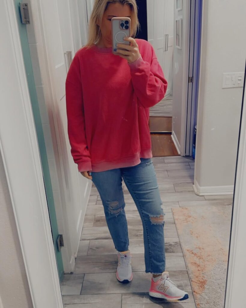 Pink Oversized Sweatshirt with Ripped Jeans and Pink New Balance Shoes