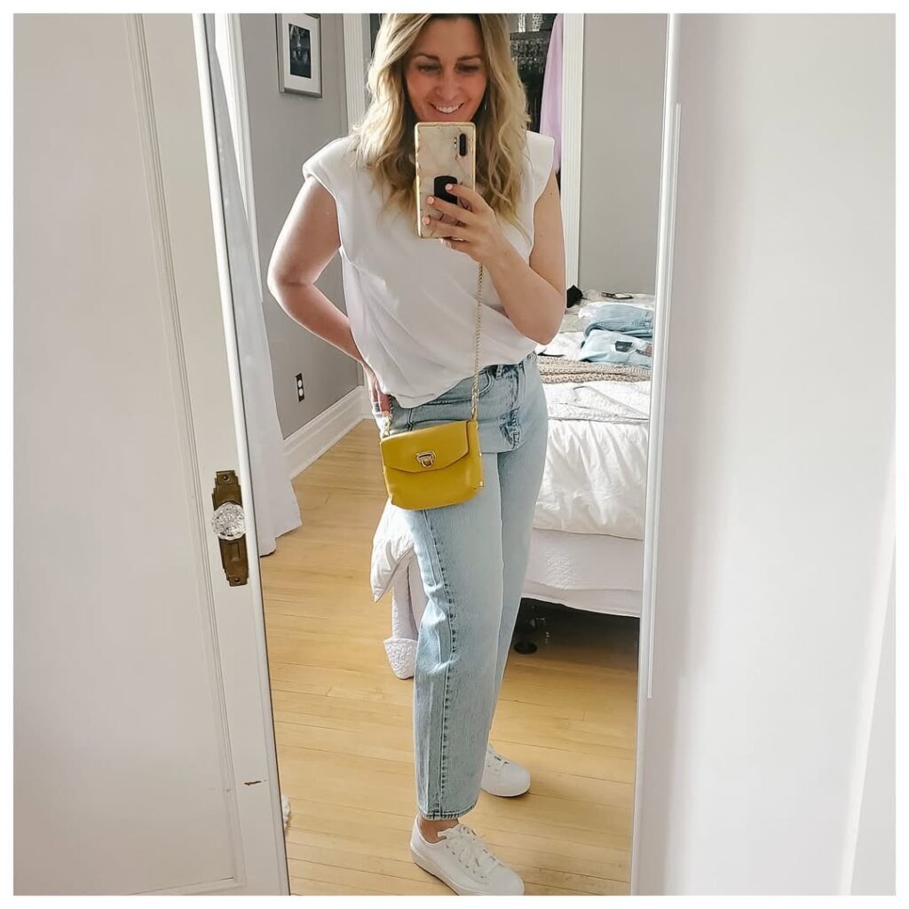 White Sleeveless Top with Light Wash Jeans and White Sneakers