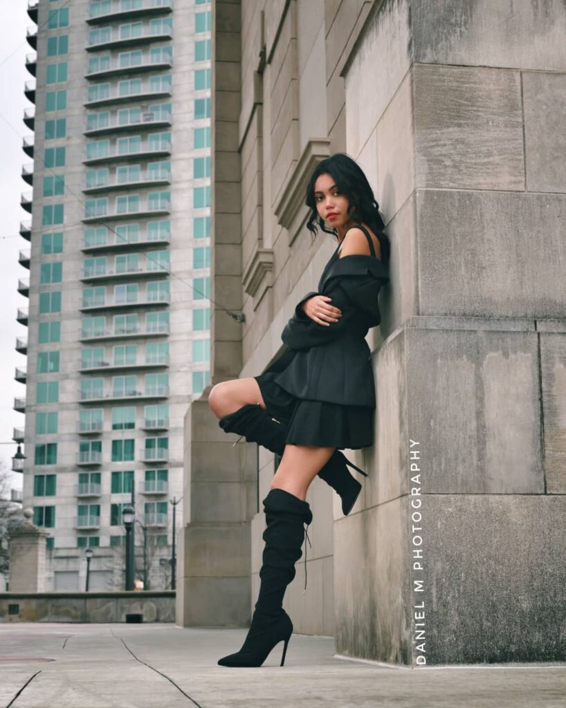 Black Off-Shoulder Mini Dress with Thigh-High Heeled Boots
