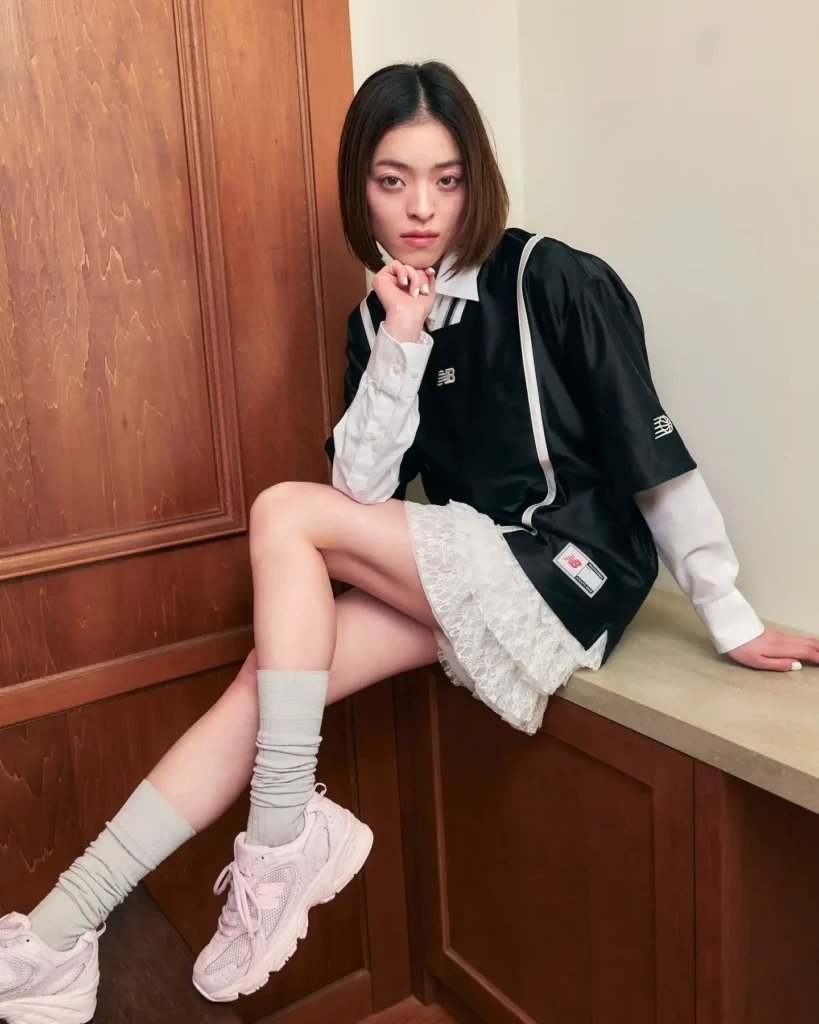 Black Jersey Top with White Lace Skirt and Pink New Balance Shoes