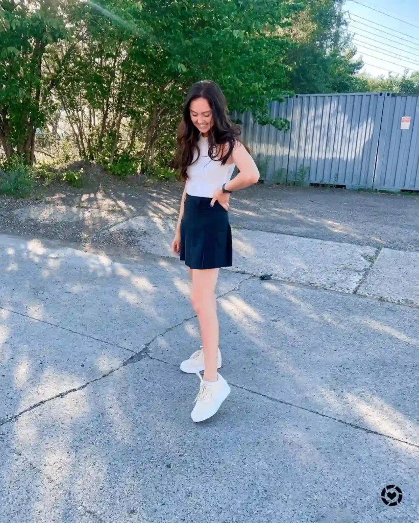 White Tank Top with Black Mini Skirt and Puma White Sneakers