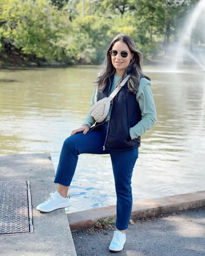 Black Puffer Vest with Blue Jeans and White Sneakers