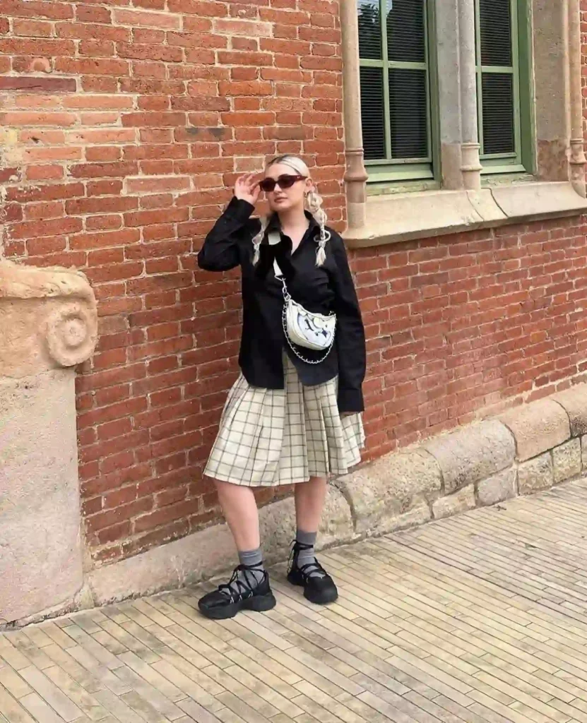 Black Shirt with Plaid Pleated Skirt Ballet Sneakers Outfit