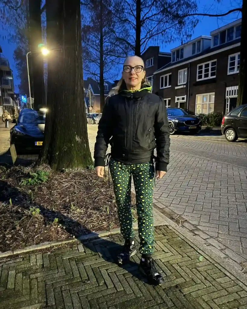 Black Bomber Jacket with Printed Pants and Black New Balance Shoes