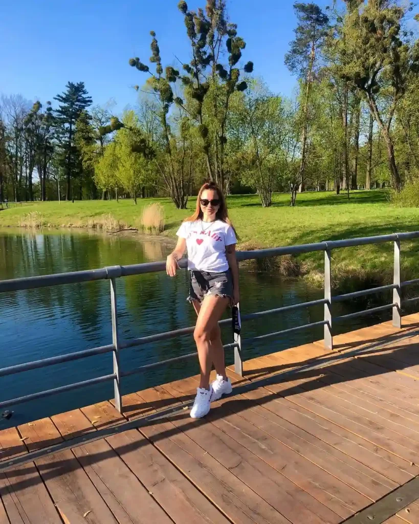 White Graphic Tee with Denim Shorts and White Sneakers