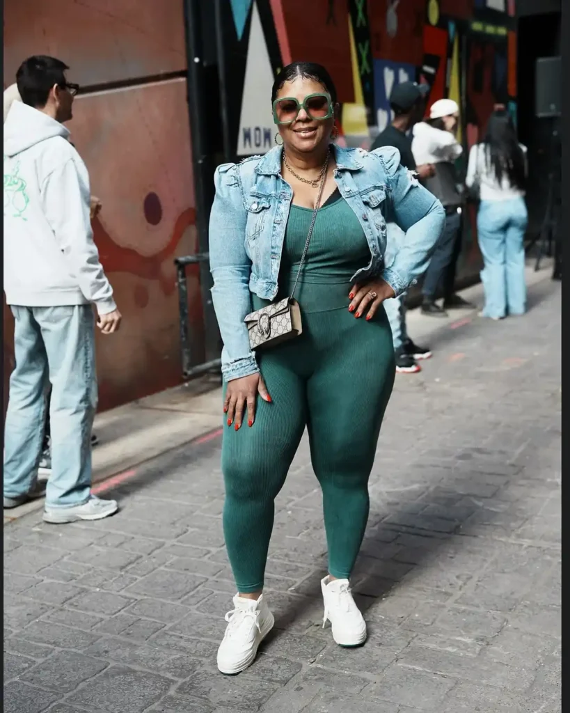 Green Jumpsuit with Cropped Denim Jacket and Reebok White Sneakers
