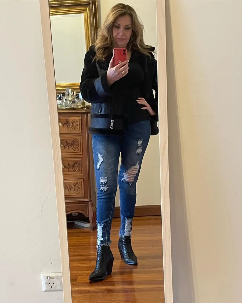 Black Shearling Jacket with Ripped Jeans and Textured Ankle Boots