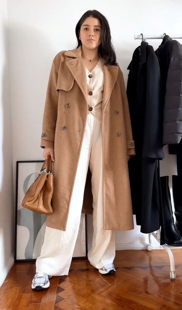 Camel Coat with a Cream Jumpsuit and Silver Sneakers