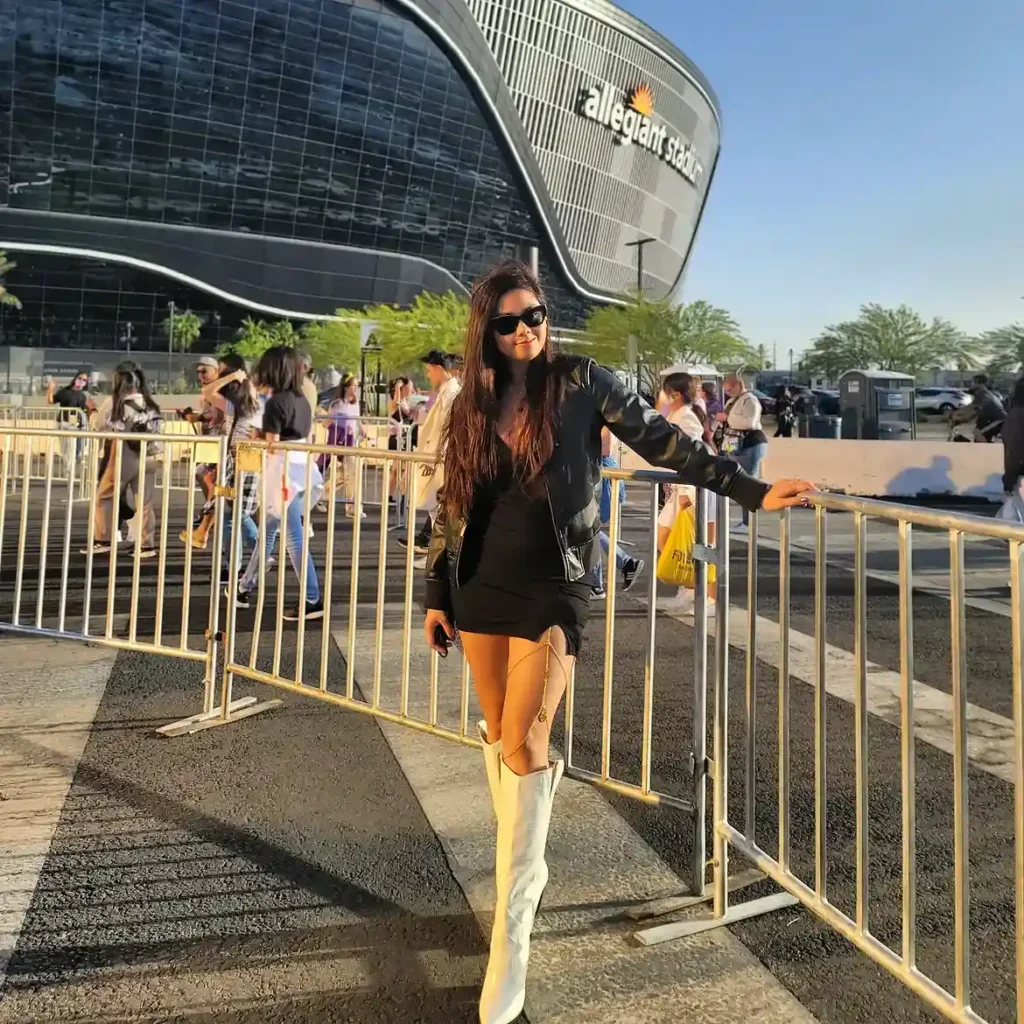 Black Mini Dress with White Knee-High Boots Concert Outfit