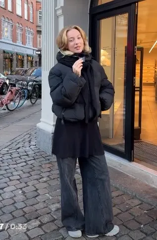 Black Puffer Jacket with Grey Wide-Leg Jeans and New Balance 740