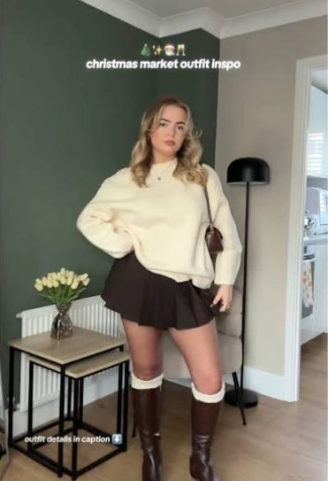 Cream Oversized Knit with a Pleated Mini Skirt and Brown Boots