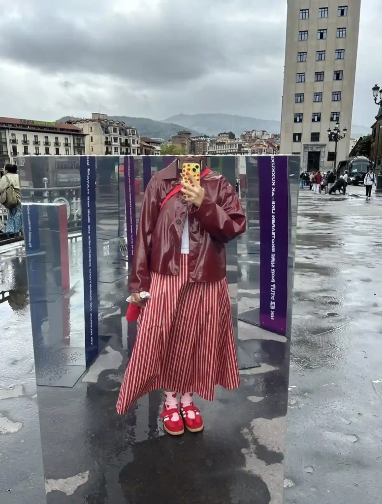 Striped Midi Skirt with Cherry Leather Jacket and Red Adidas Sambas