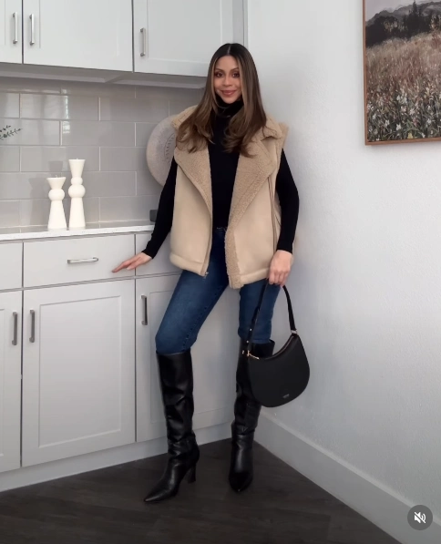 Shearling Vest over a Turtleneck with Jeans and Knee-High Boots