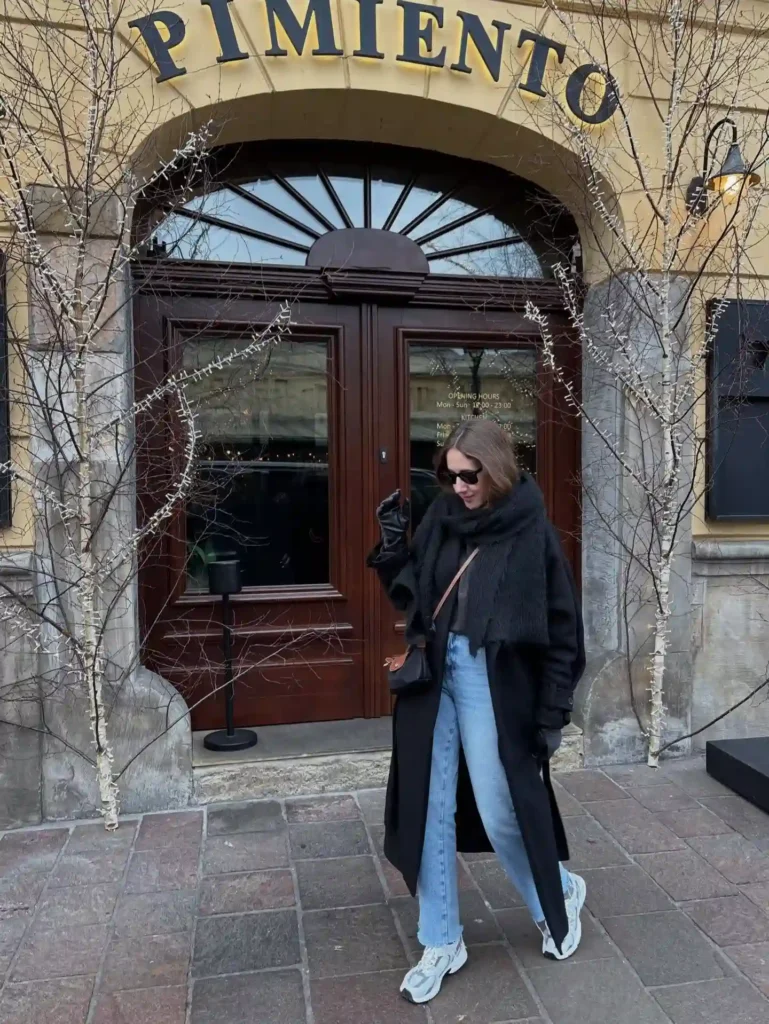Long Black Coat and Light Jeans with White Sneakers