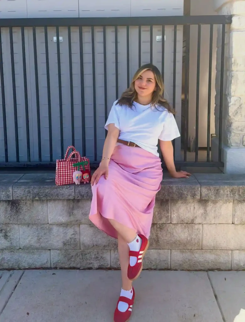 White Tee with Pink Satin Midi Skirt and Red Adidas Sambas