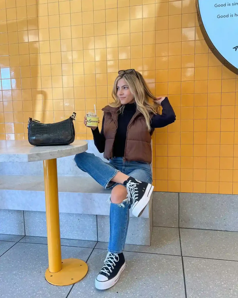 Puffer Vest and Ripped Jeans with High-Top Sneakers