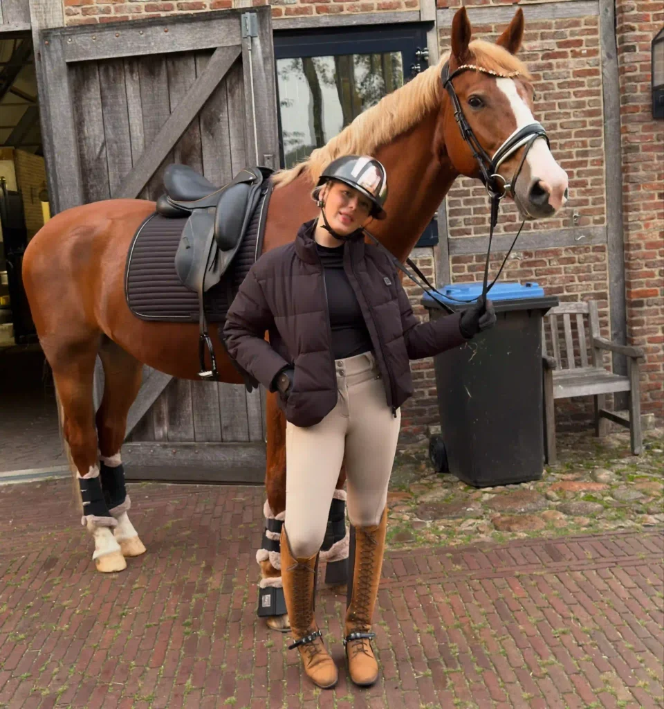 Puffer Jacket and Beige Breeches with Tall Riding Boots
