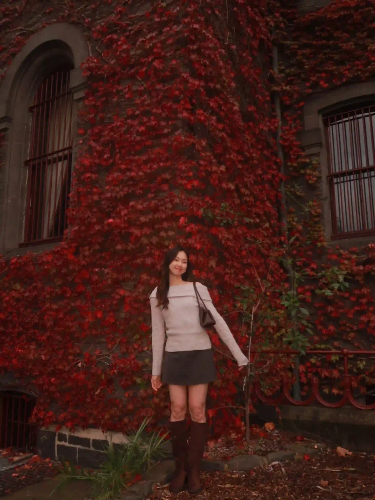 Off-Shoulder Knit with Dark Mini Skirt and Brown Knee High Boots