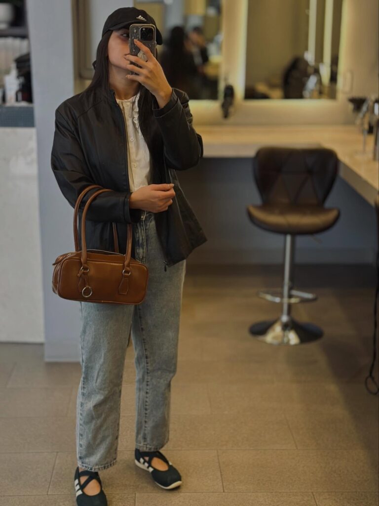 Leather Jacket with Ruffle Blouse and Light Jeans